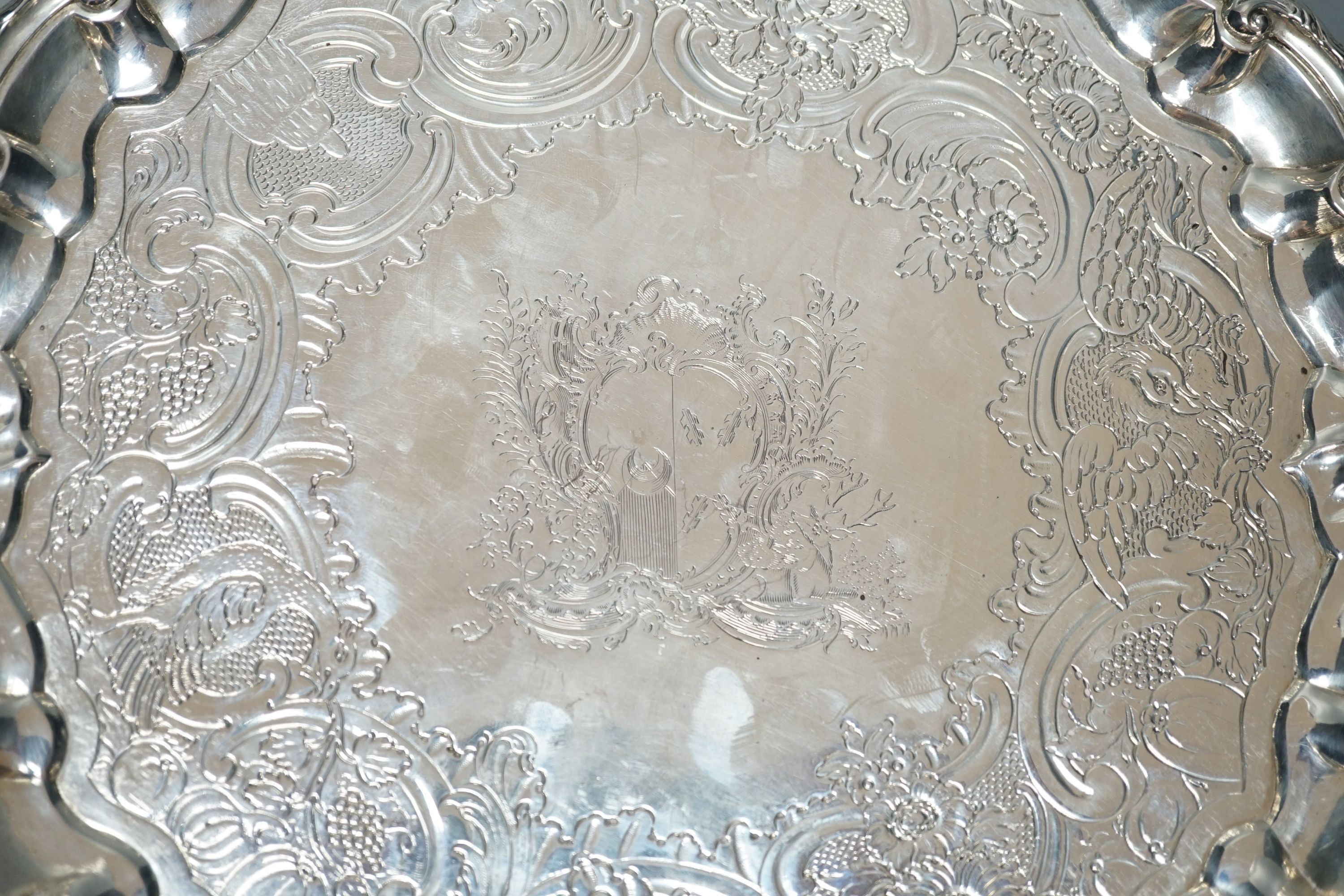 A George II silver salver, Hugh Mills, London, 1748, with later engraved decoration, 28.6cm, 25.5 oz (a.f.).